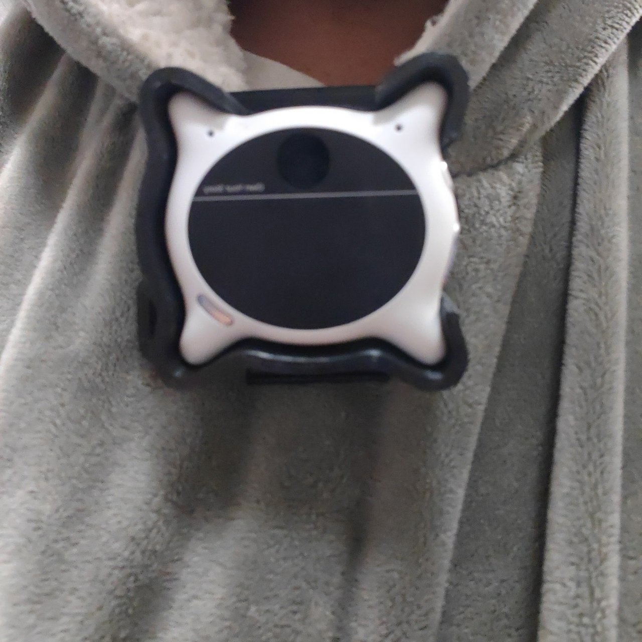 The Looki L1 in the printed v9 holder, clipped to a hoodie collar